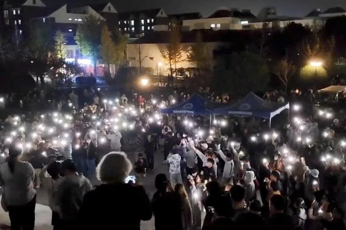People protest at Communication University of China in Nanjing, Jiangsu province, China in this still image obtained by REUTERS from a video released November 26, 2022. THIS IMAGE HAS BEEN SUPPLIED BY A THIRD PARTY. NO RESALES. NO ARCHIVES. THE LOCATION OF THE VIDEO WAS VERIFIED BY BUILDING CHARACTERISTICS WHICH MATCHED FILE IMAGERY. REUTERS WAS NOT ABLE TO INDEPENDENTLY CONFIRM THE DATE THE VIDEO WAS FILMED.