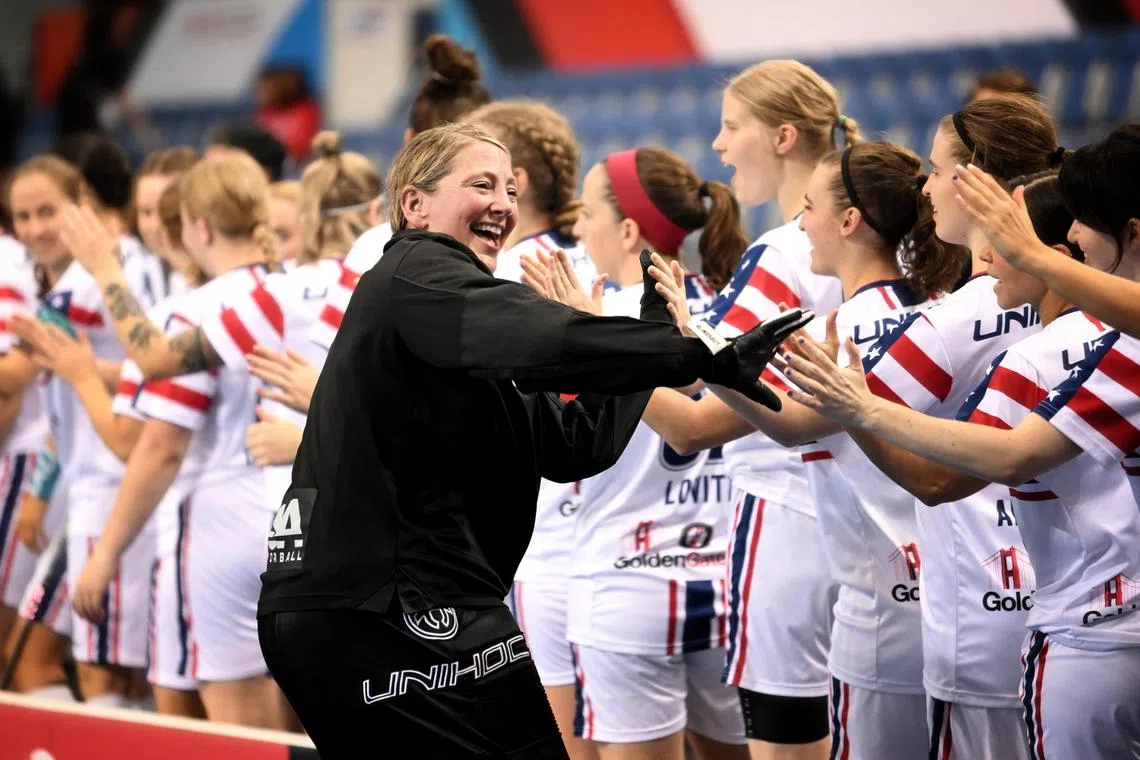 Megan Addington, the US's 51-year-old goalkeeper exchanges high-fives with her teammates before the match between US and Estonia. 
