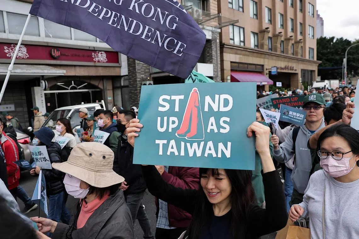 People join in the "Stand up as Taiwan" rally in Taipei on Dec 8 amid reports of upcoming Chinese military exercises.