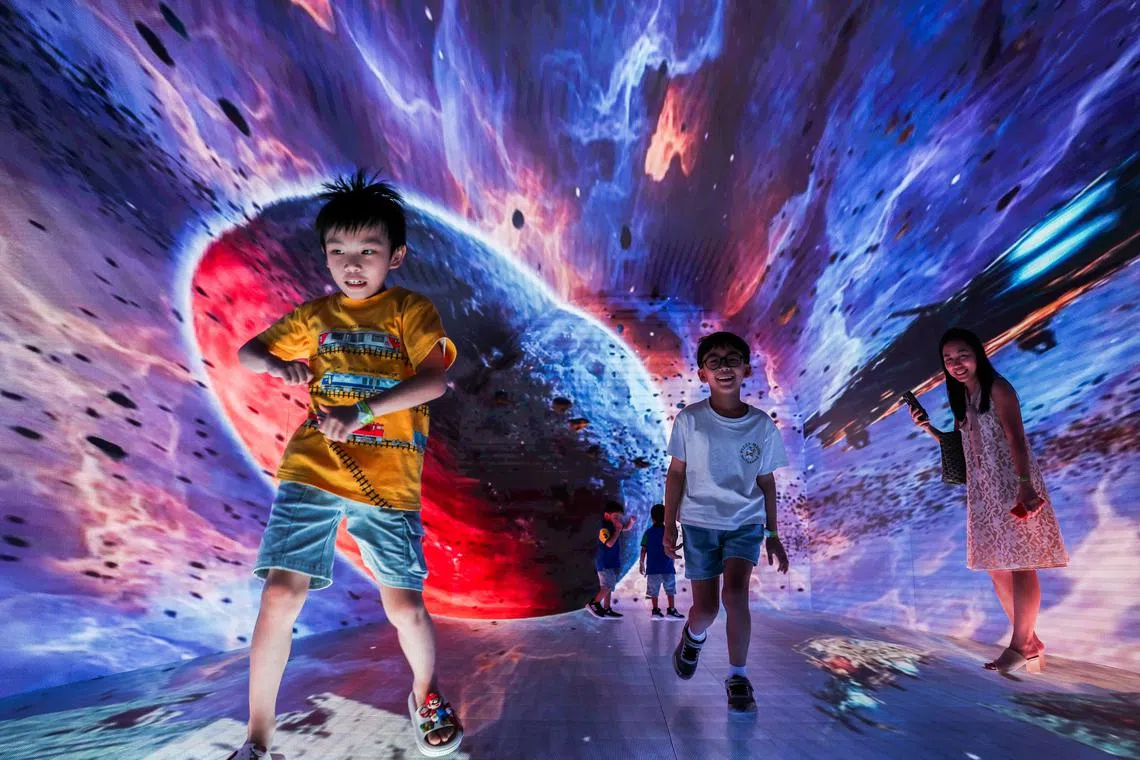 Purawish Bunyagarn, 7 and other children attend Space & Time Cube+, a cutting‑edge immersive art and metaverse-inspired experience, in Bangkok, Thailand, July 23, 2025. 