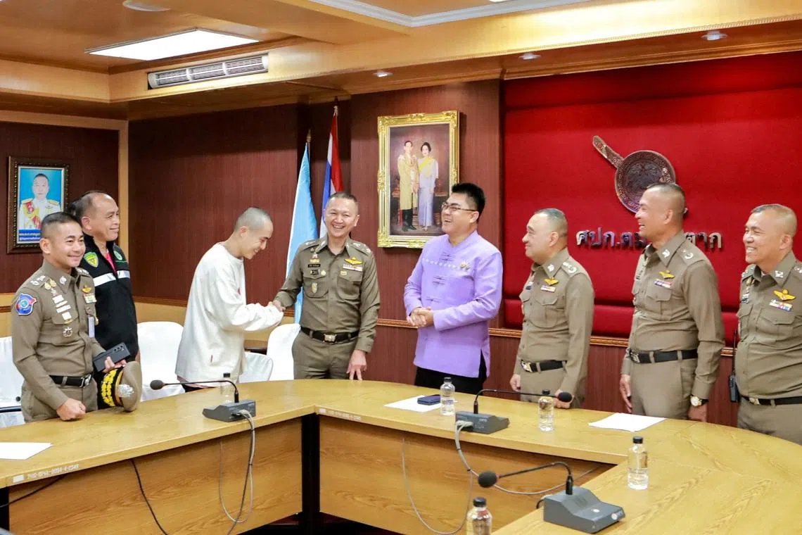 FILE PHOTO: Chinese actor Wang Xing shakes hands with a Thai police officer after being assisted in his return to the country, after being kidnapped into one of the telecom fraud centers, at a police station in Thailand-Myanmar border's Mae Sot district, Tak province, Thailand, January 7, 2025. Royal Thai Police/Handout via REUTERS ATTENTION EDITORS - THIS IMAGE HAS BEEN SUPPLIED BY A THIRD PARTY. NO RESALES. NO ARCHIVES/File Photo