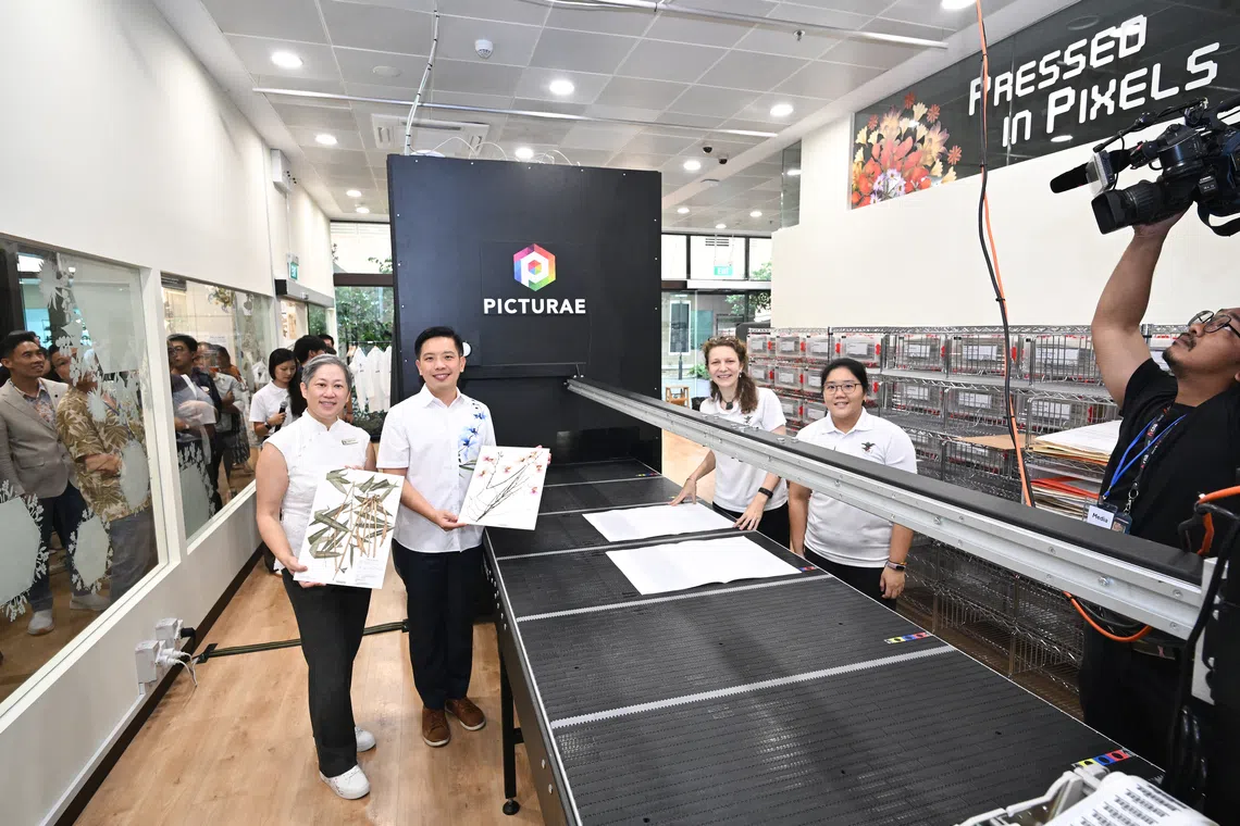 Minister of State for National Development Alvin Tan (second from left) digitising a Papilionanthe Miss Joaquim (Vanda Miss Joaquim) specimen on Oct 28.