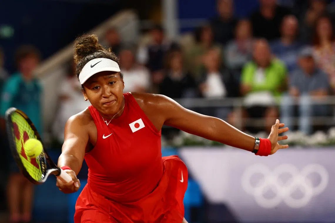 Paris 2024 Olympics - Tennis - Women's Singles First Round - Roland-Garros Stadium, Paris, France - July 27, 2024. Naomi Osaka of Japan in action during her first round match against Angelique Kerber of Germany. REUTERS/Edgar Su