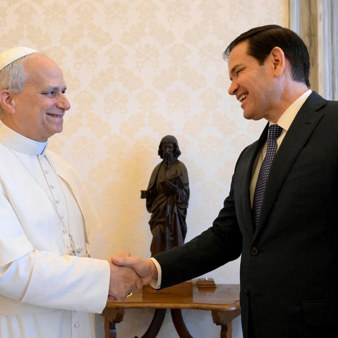 FILE PHOTO: Pope Leo XIV shakes hands with U.S. Secretary of State Marco Rubio as they meet at the Vatican, May 19, 2025. Vatican Media/­Simone Risoluti/Handout via REUTERS    ATTENTION EDITORS - THIS IMAGE WAS PROVIDED BY A THIRD PARTY./File Photo