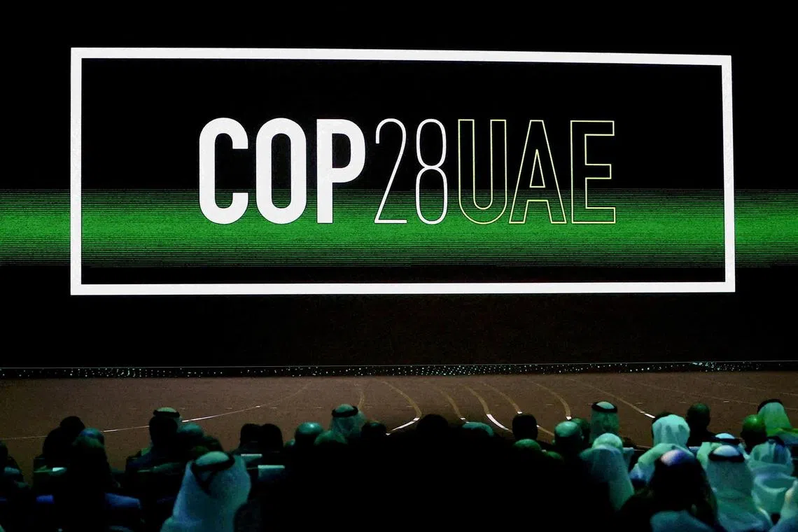 FILE PHOTO: 'Cop28 UAE' logo is displayed on the screen during the opening ceremony of Abu Dhabi Sustainability Week (ADSW) under the theme of 'United on Climate Action Toward COP28', in Abu Dhabi, UAE, January 16, 2023. REUTERS/Rula Rouhana//File Photo