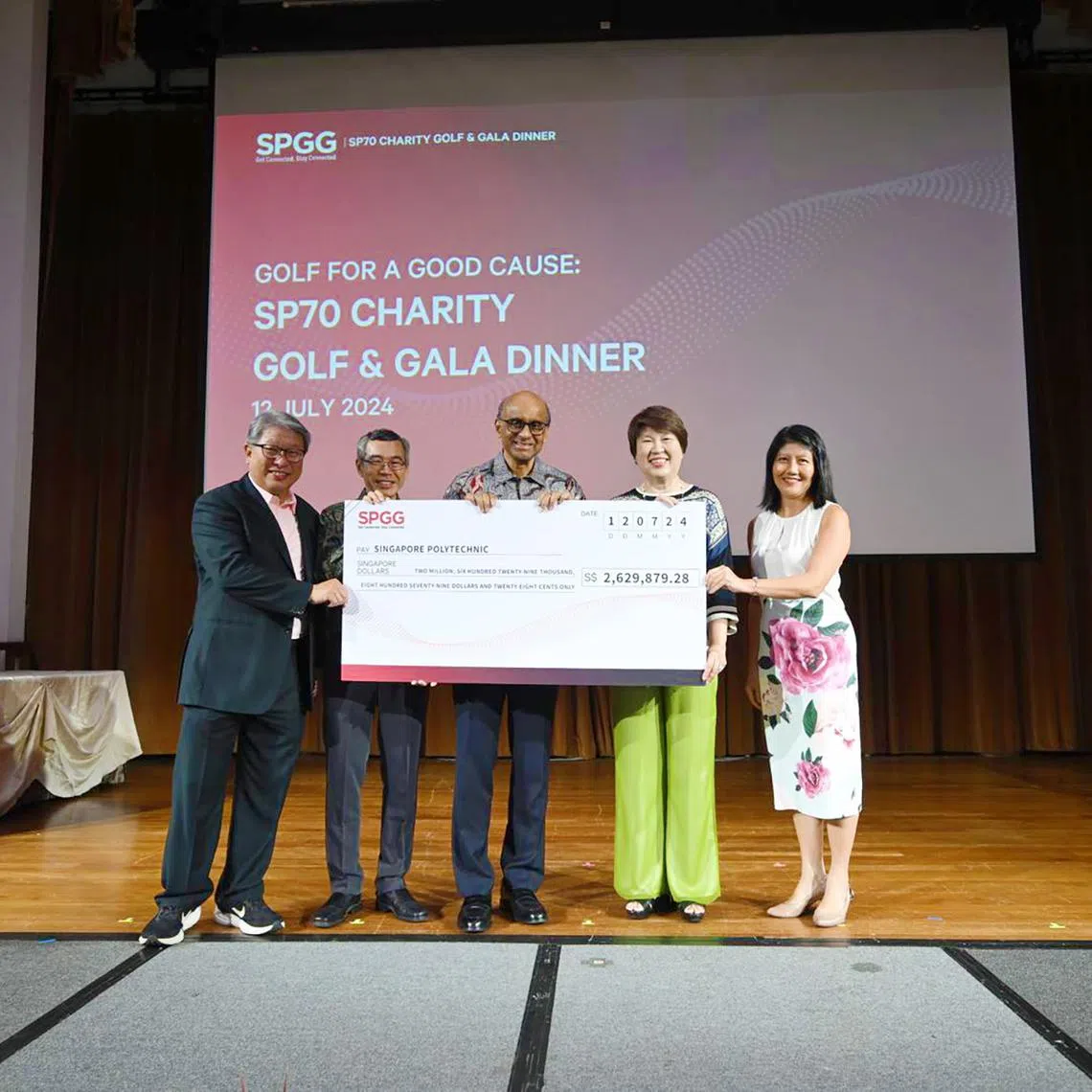 (From left) President of Singapore Polytechnic Graduates' Guild Jimmy Lim, Singapore Polytechnic principal and CEO Soh Wai Wah, President Tharman Shanmugaratnam, SP Board of Governors chariman Janet Ang and National Council of Social Service CEO Tan Li San with the the cheque of $2,629,879.28 for needy students.