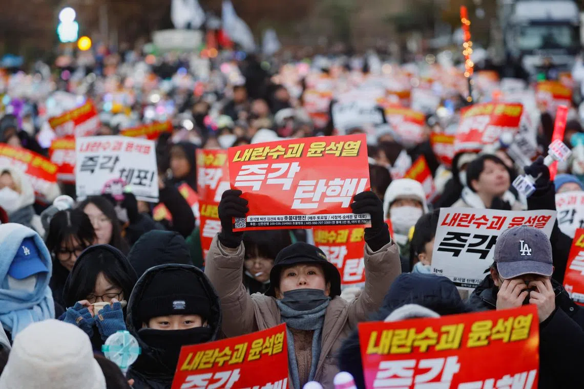 Protesters hold banners in a rally calling for the impeachment of South Korean President Yoon Suk Yeol in Seoul, South Korea on Dec 8, 2024. 
