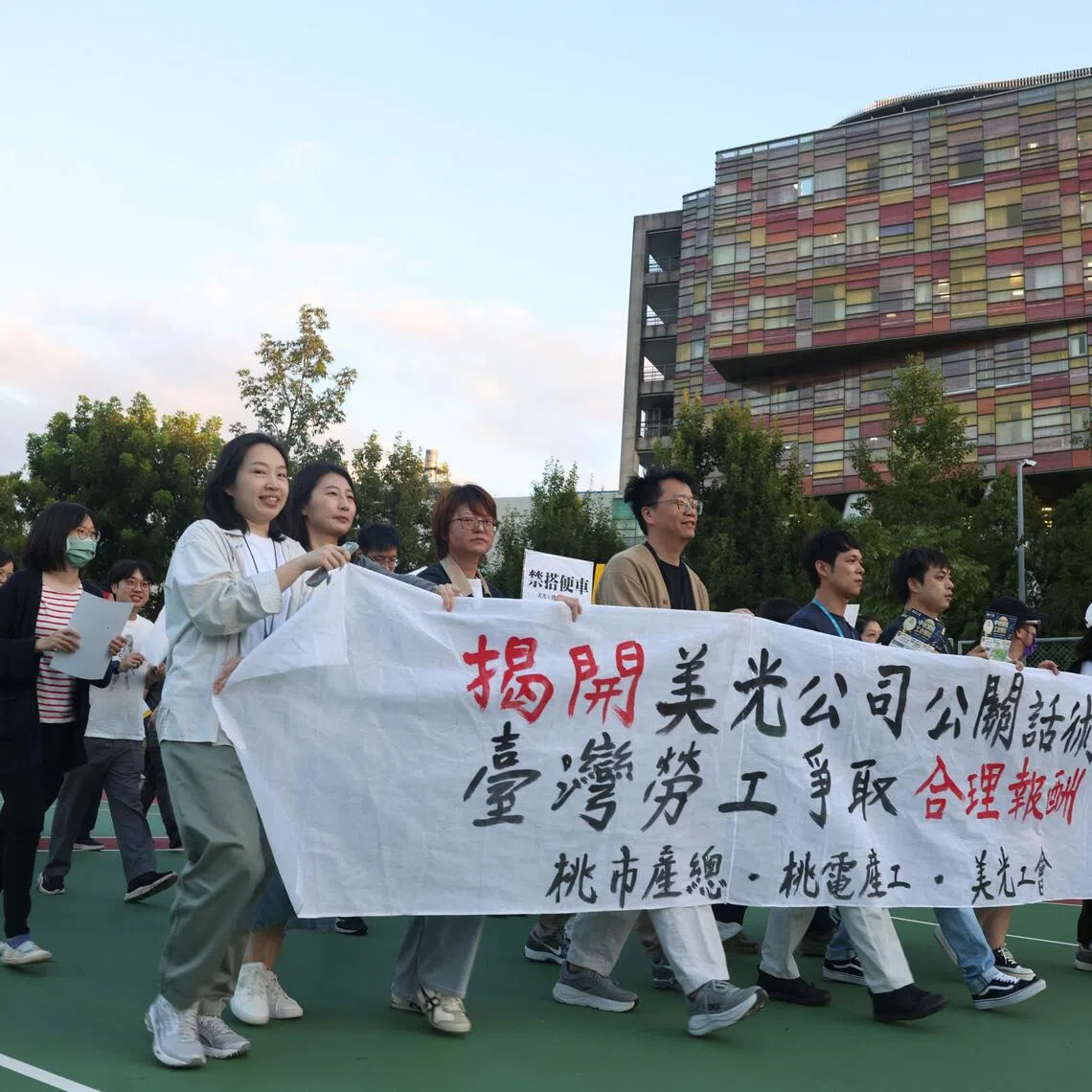 Micron Taiwan employees with a banner reading “Expose Micron’s PR rhetoric, Taiwanese workers demand fair compensation” during a union rally in Taoyuan, on Sept 17.