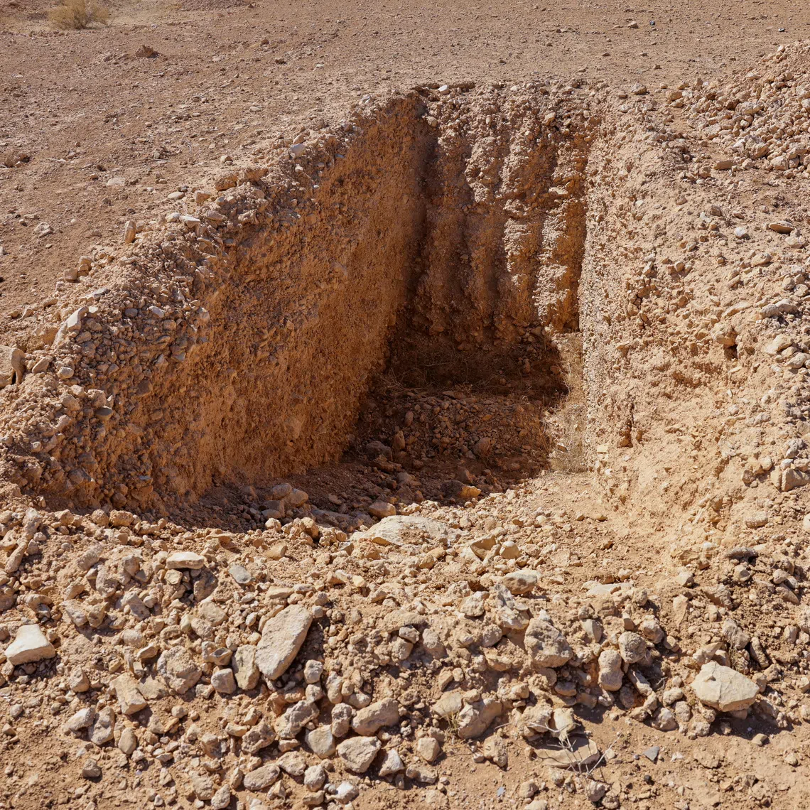 FILE PHOTO: A detail of what one witness told Reuters was an incomplete trench dug to take bodies in this mass grave site in the desert near the eastern Syrian town of Dhumair, February 27, 2025. REUTERS/Khalil Ashawi/File Photo