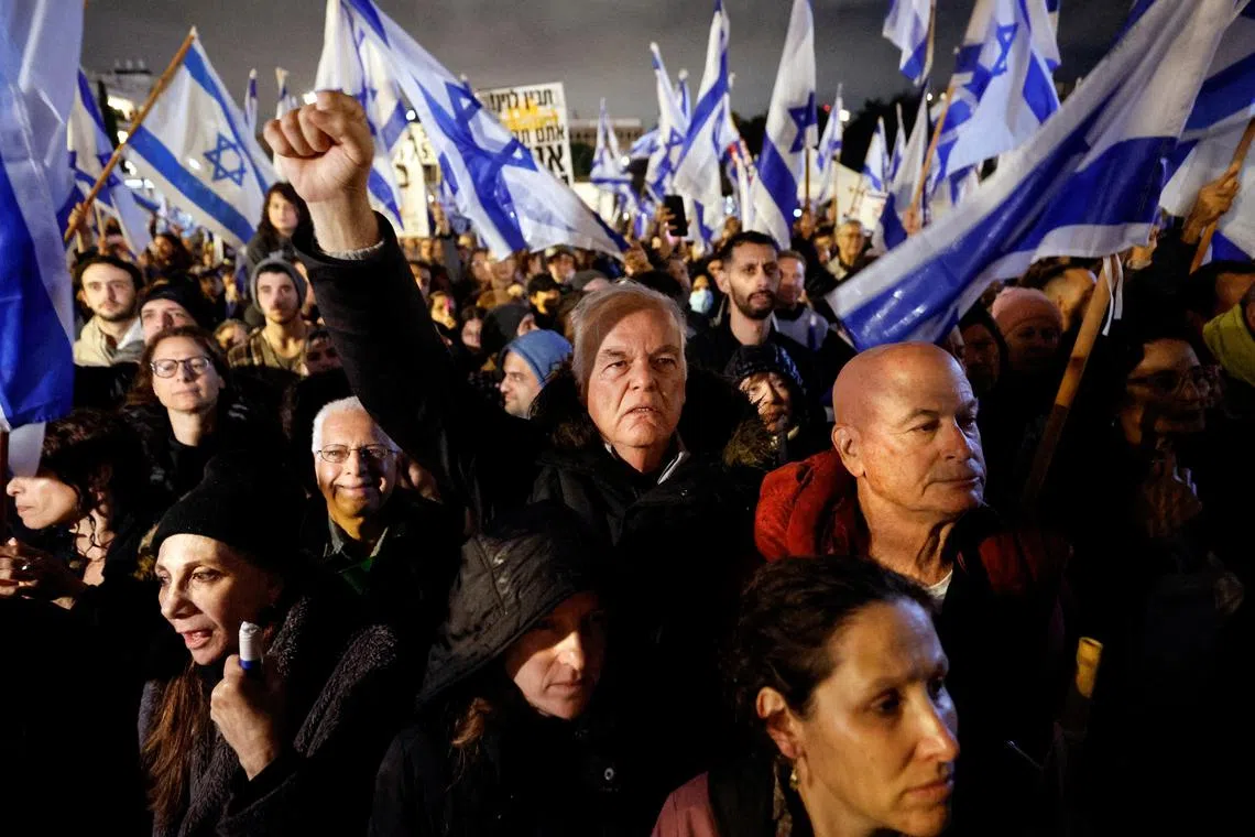 Israelis protesting against PM Benjamin Netanyahu's new right-wing coalition and its proposed judicial reforms in Tel Aviv on Jan 14, 2023.