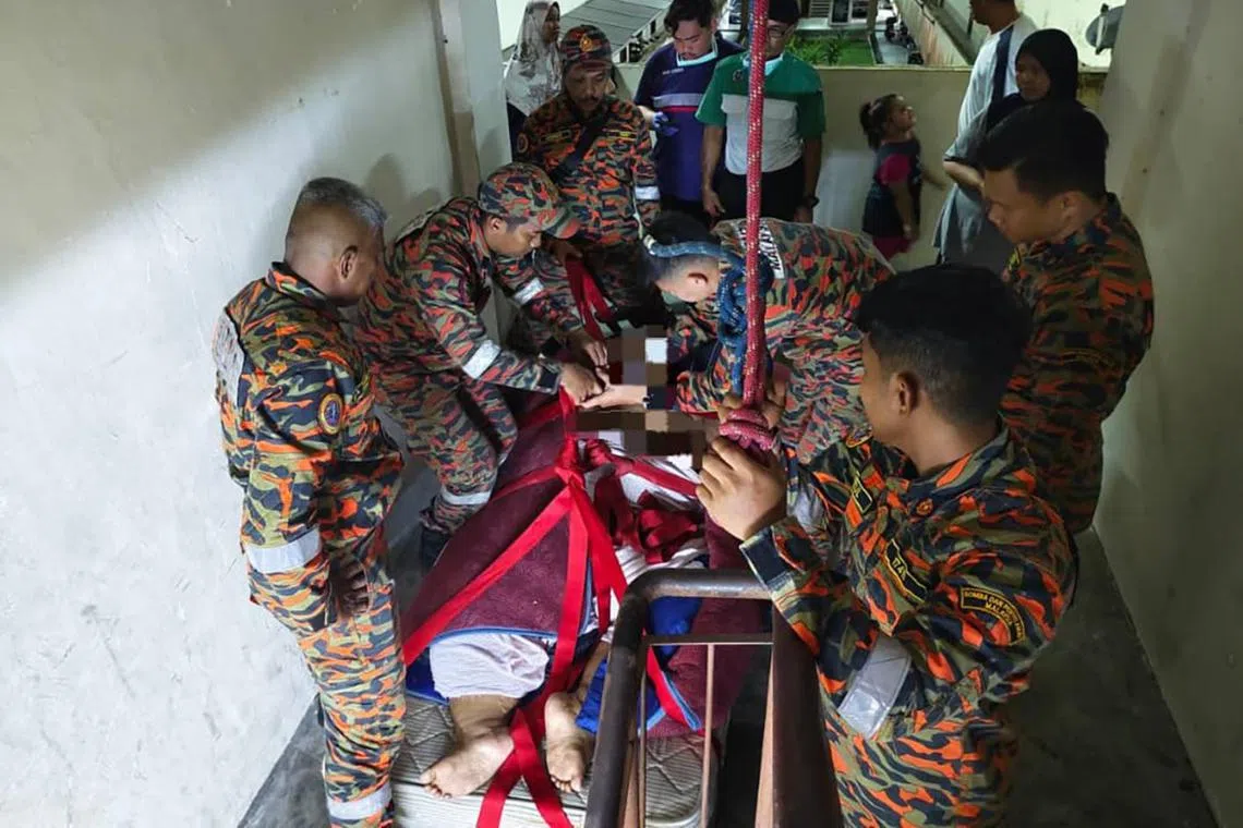 Johor firefighters carry 200kg man with breathing difficulties from third-floor home to ambulance