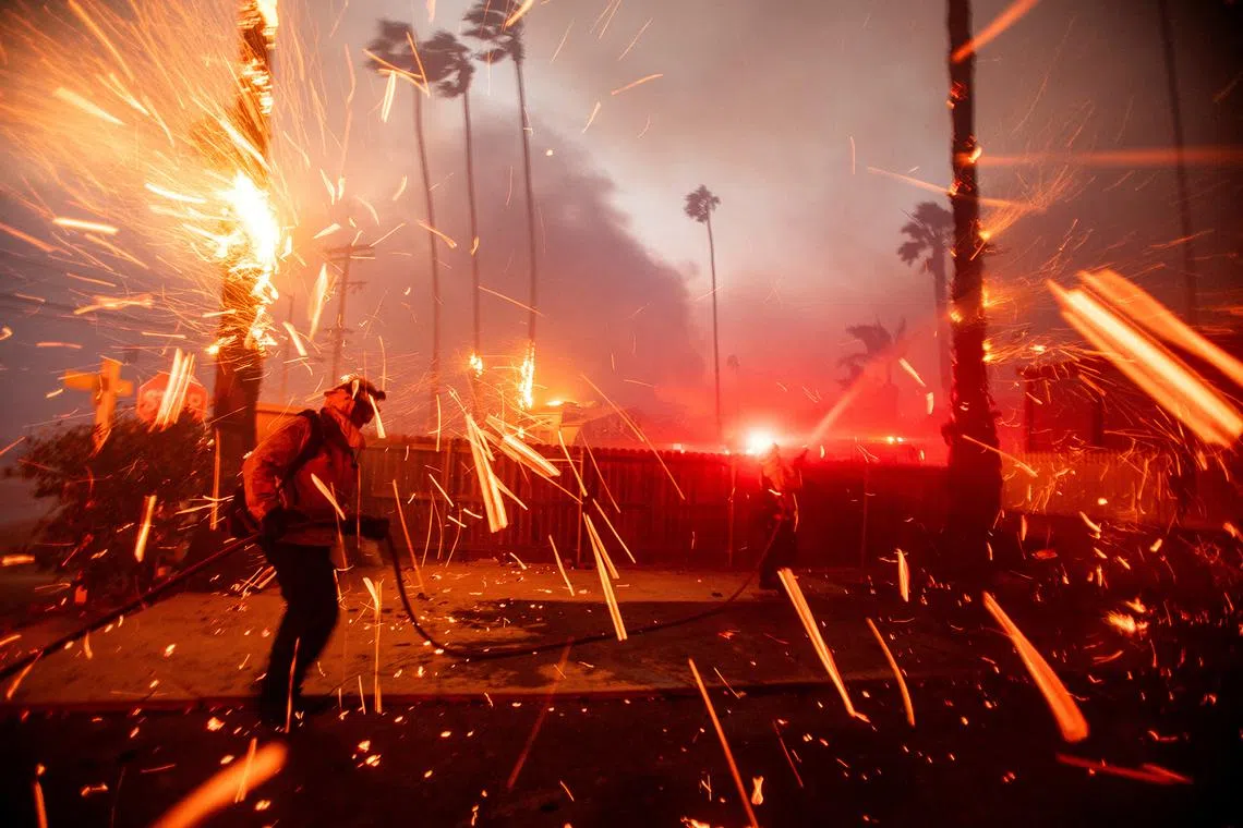 Firefighters battling the Palisades wildire as it burns during a windstorm on the west side of Los Angeles on Jan 7, 2025. 