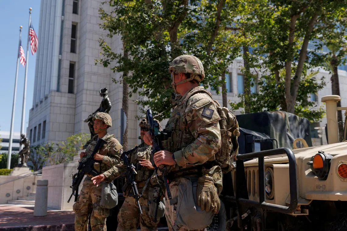 FILE PHOTO: Members of the California National Guard are deployed outside a complex of federal buildings in Santa Ana, California, U.S. June, 18, 2025.  REUTERS/Mike Blake/File Photo
