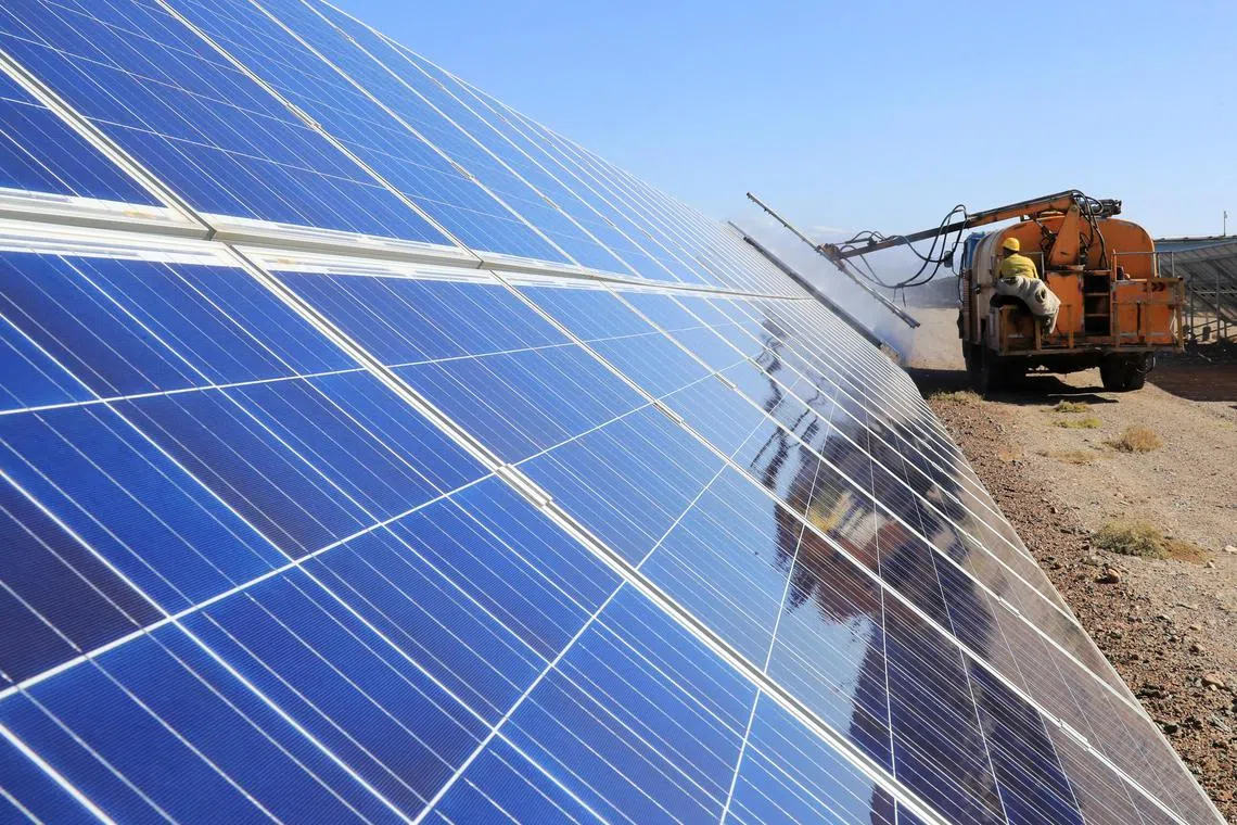 FILE PHOTO: A worker operates a machinery to clean solar panels at a photovoltaic industrial park in Hami, Xinjiang Uighur Autonomous Region, China October 22, 2018. Picture taken October 22, 2018.   REUTERS/Stringer ATTENTION EDITORS - THIS IMAGE WAS PROVIDED BY A THIRD PARTY. CHINA OUT./File Photo