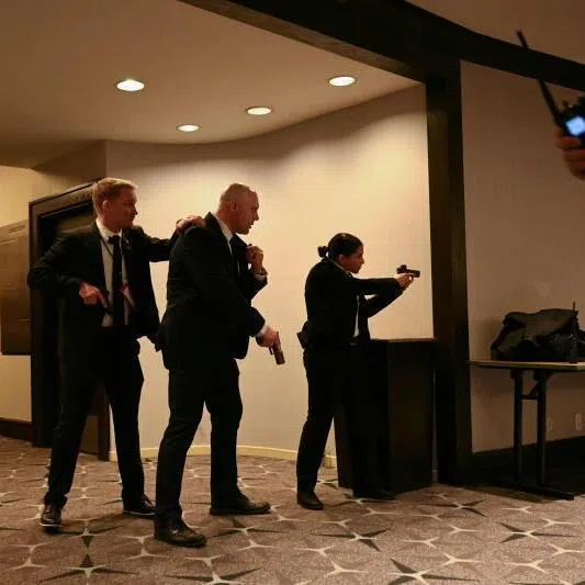 Agents drawing their guns after loud bangs were heard during the White House Correspondents' dinner at the Washington Hilton in Washington DC, on April 25.