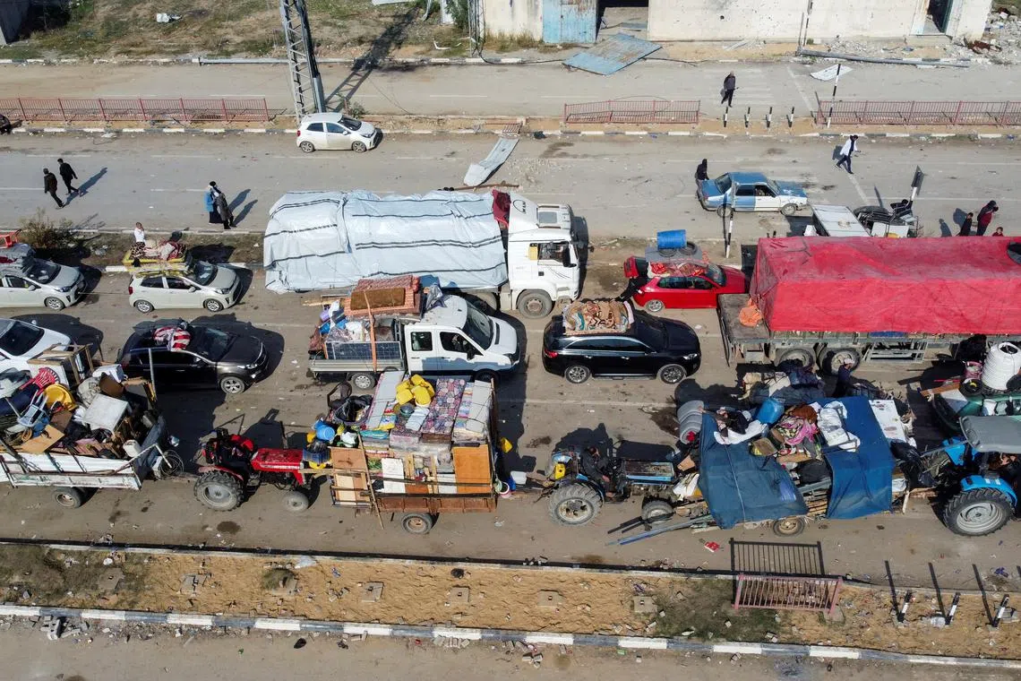 FILE PHOTO: A drone view shows displaced Palestinians waiting to have their vehicles inspected by the Egyptian-Qatari committee as they return to their homes in northern Gaza from the south, at Salahudeen Road, amid a ceasefire between Israel and Hamas, in the central Gaza Strip, January 28, 2025. REUTERS/Mohammed Salem/File Photo