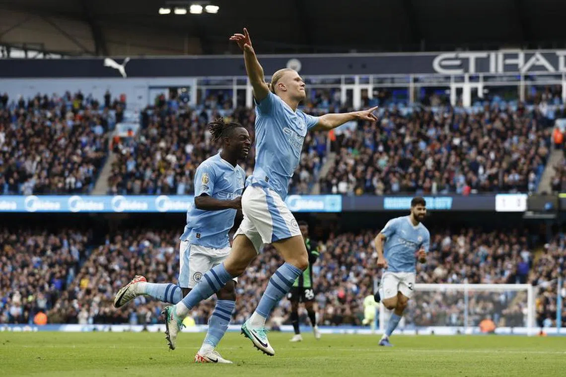Soccer Football - Premier League - Manchester City v Brighton & Hove Albion - Etihad Stadium, Manchester, Britain - October 21, 2023  Manchester City's Erling Braut Haaland celebrates scoring their second goal with Jeremy Doku Action Images via Reuters/Jason Cairnduff