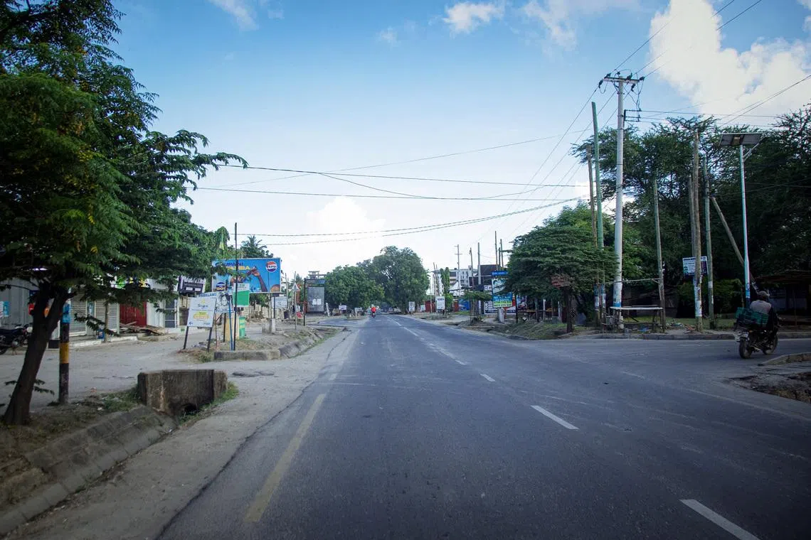 A motorcyclist rides on a deserted street during the 64th Independence Day under a lockdown imposed by the government to counter planned anti-government protests against deadly violence during demonstrations around the October elections, in Dar es Salaam, Tanzania, December 9, 2025. REUTERS/Emmanuel Herman