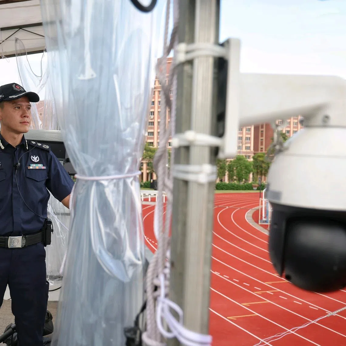 The Bedok Police Division’s commander, Senior Assistant Commissioner SAC Justin Wong, on a watchtower set up by the police at a rally site.