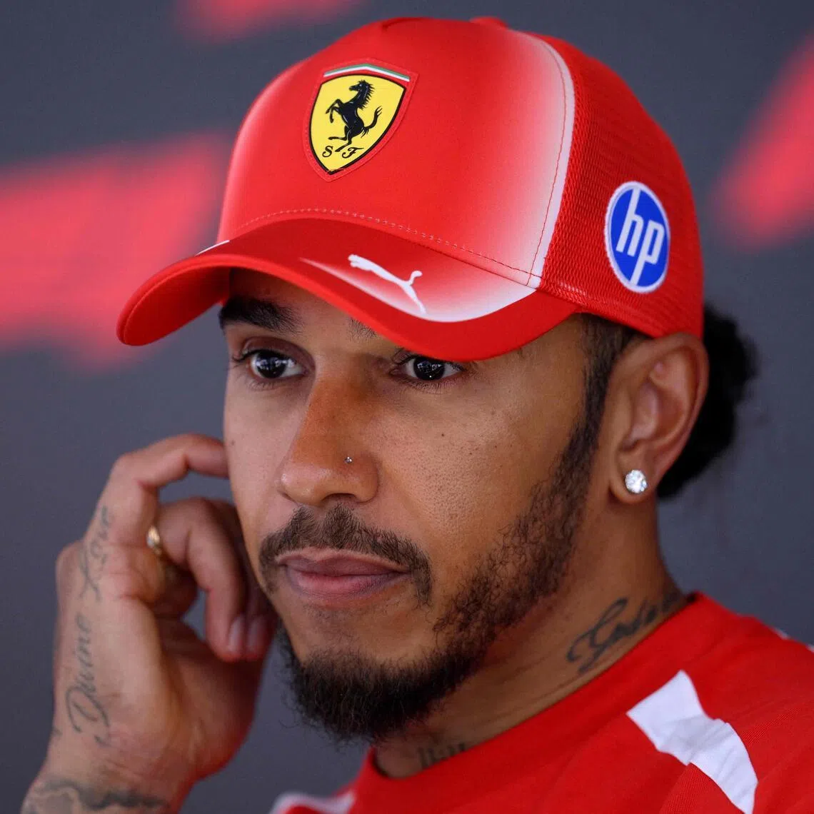 Ferrari’s British driver Lewis Hamilton talks to the media in the paddock of the Spa-Francorchamps circuit.