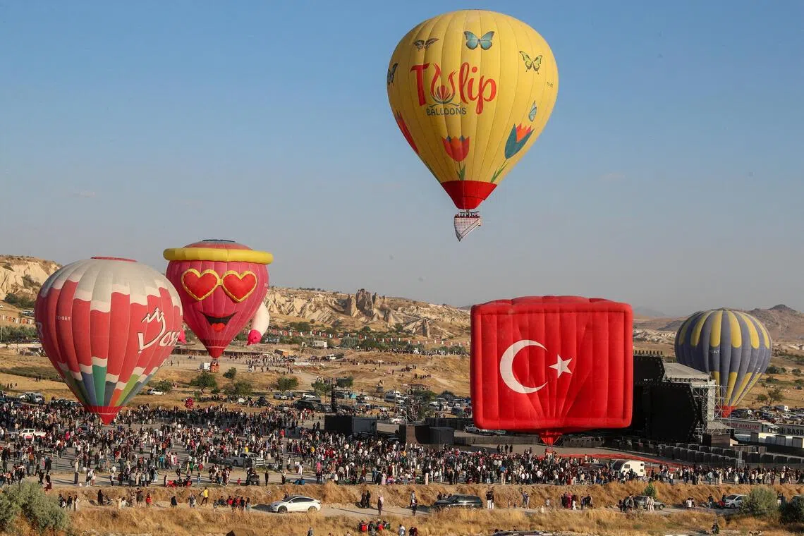Hot air balloons fly during the 7th International Cappadocia Balloon Festival in Goreme, Nevsehir province, Turkey, August 2, 2026. REUTERS/Cagla Gurdogan     TPX IMAGES OF THE DAY     
