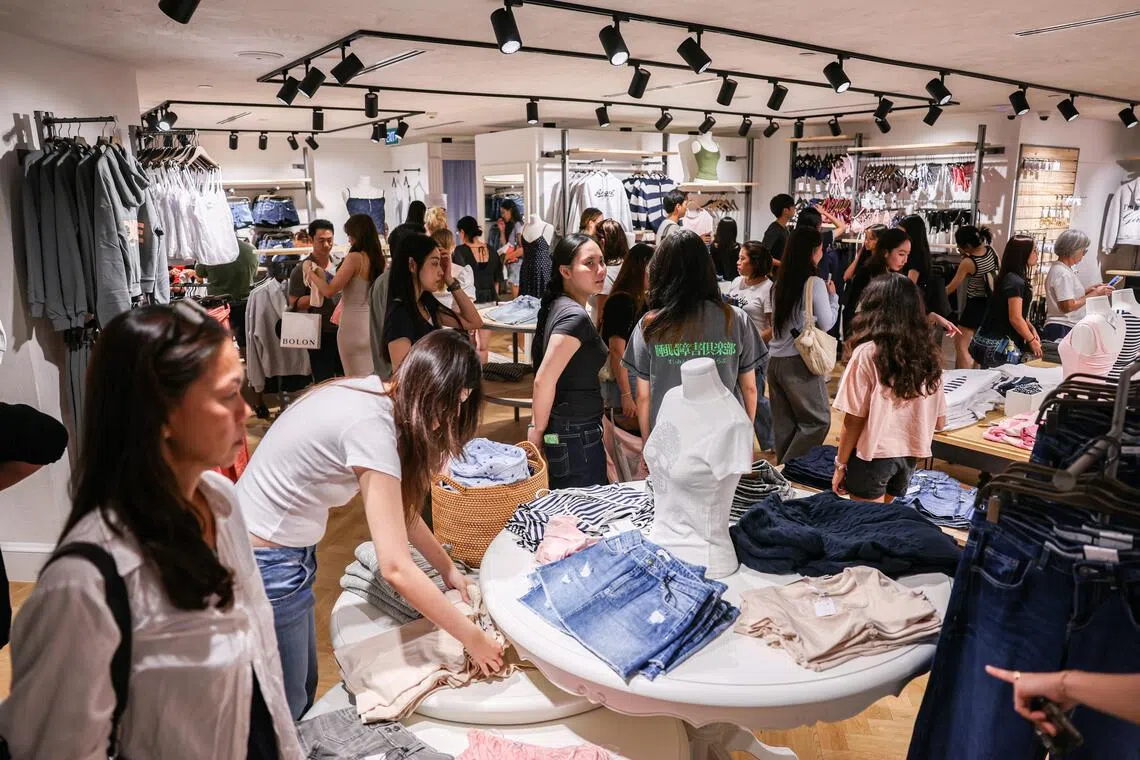 Shoppers throng the Subdued clothing store at Wheelock Place on April 18.