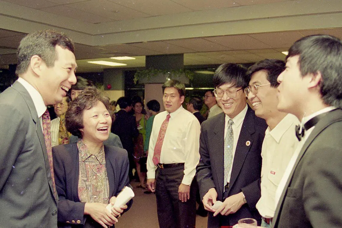 Then DPM Lee Hsien Loong (left) chatting with a young Professor Wang Huning (second right) at an international debating competition held in Singapore in 1993.