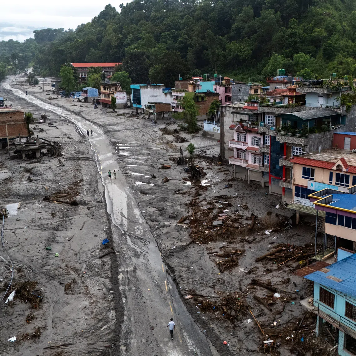A drone view shows houses covered in mud following deadly flash floods and mudslides, in Devighat, Nuwakot district, Nepal.