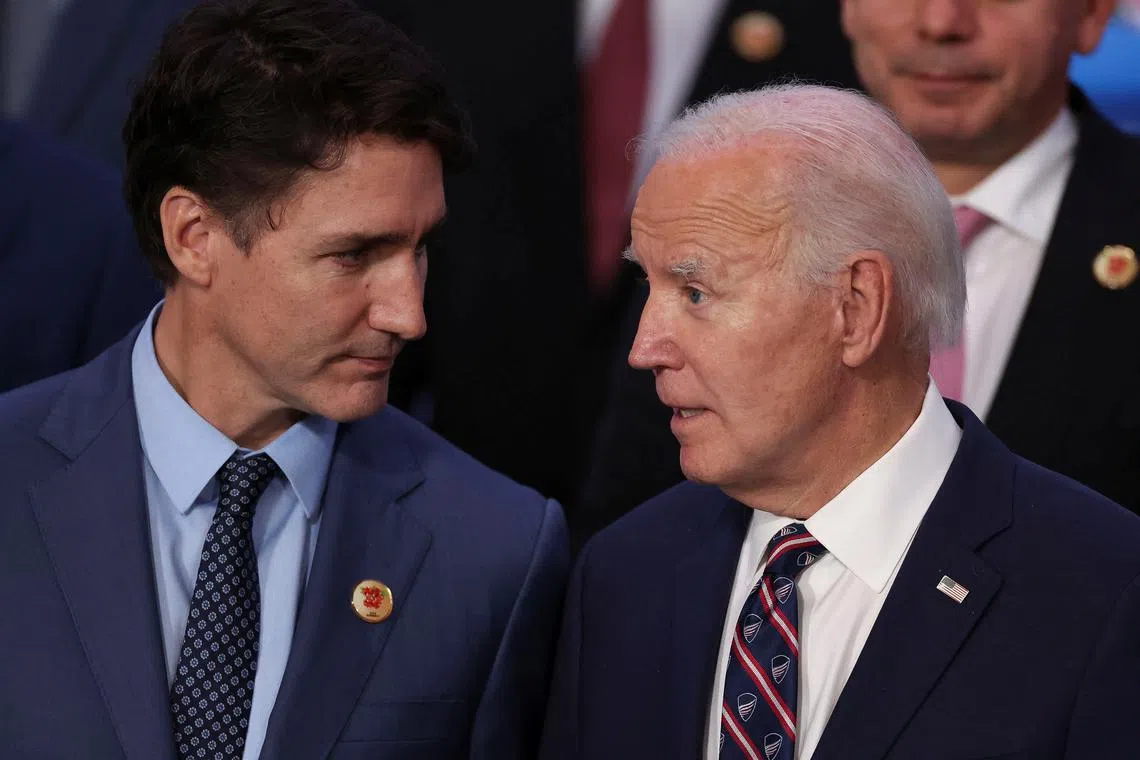FILE PHOTO: U.S. President Joe Biden and Canada's Prime Minister Justin Trudeau speak as leaders prepare for a group picture at the G20 summit in Rio de Janeiro, Brazil, November 19, 2024. REUTERS/Pilar Olivares/File Photo