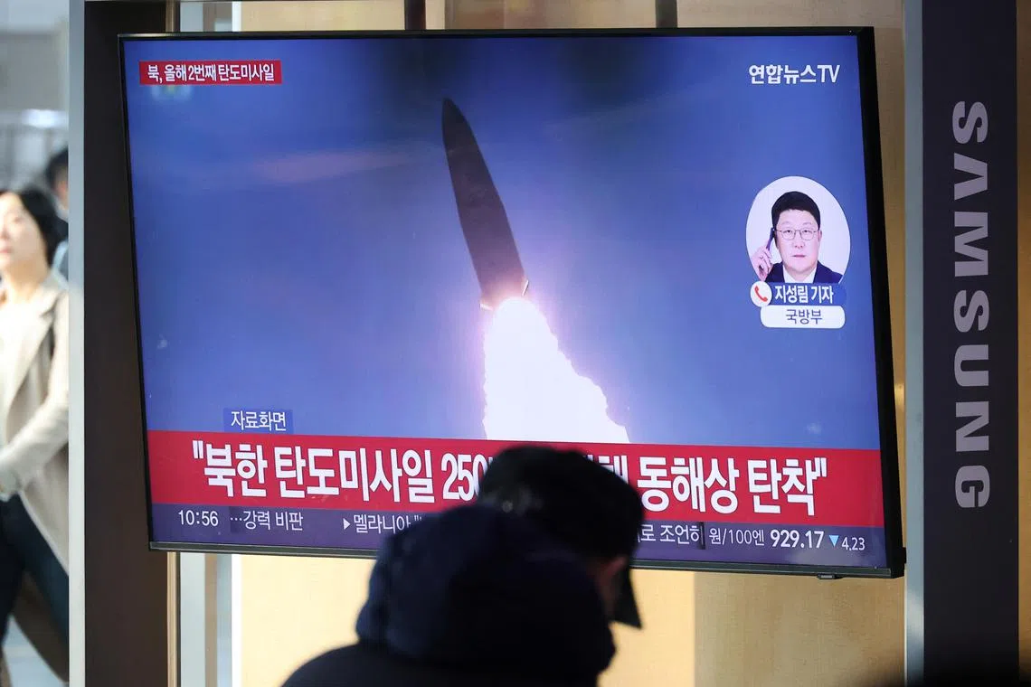 People watch a TV broadcasting a news report on North Korea firing multiple short-range missiles, in Seoul, South Korea, on Jan 14.
