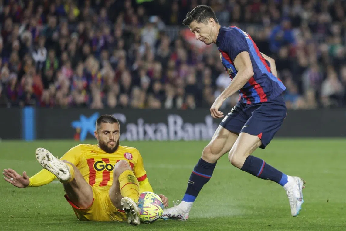 Barcelona's Robert Lewandowski in action against Girona's David Lopez Silva during their La Liga match in Barcelona, Spain.