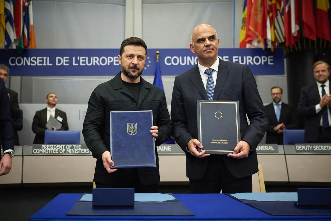 Ukrainian President Volodymyr Zelensky (left) and Council of Europe secretary-general Alain Berset signed the accord in Strasbourg on June 25.