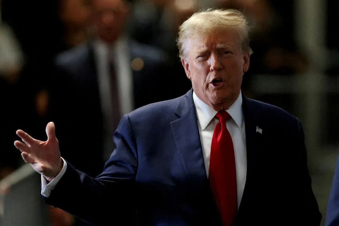 FILE PHOTO: Former U.S. President Donald Trump gestures on the day of a court hearing on charges of falsifying business records to cover up a hush money payment to a porn star before the 2016 election, in New York State Supreme Court in the Manhattan borough of New York City, U.S., February 15, 2024. REUTERS/Andrew Kelly/File Photo