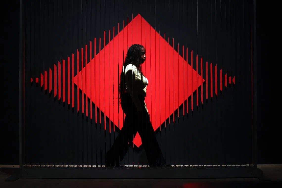 A Tate Modern staff walking past the artwork titled '64 Reflective Blades' during the press preview of Argentine artist Julio Le Parc, at the Tate Modern in London, Britain, June 8, 2026. 
