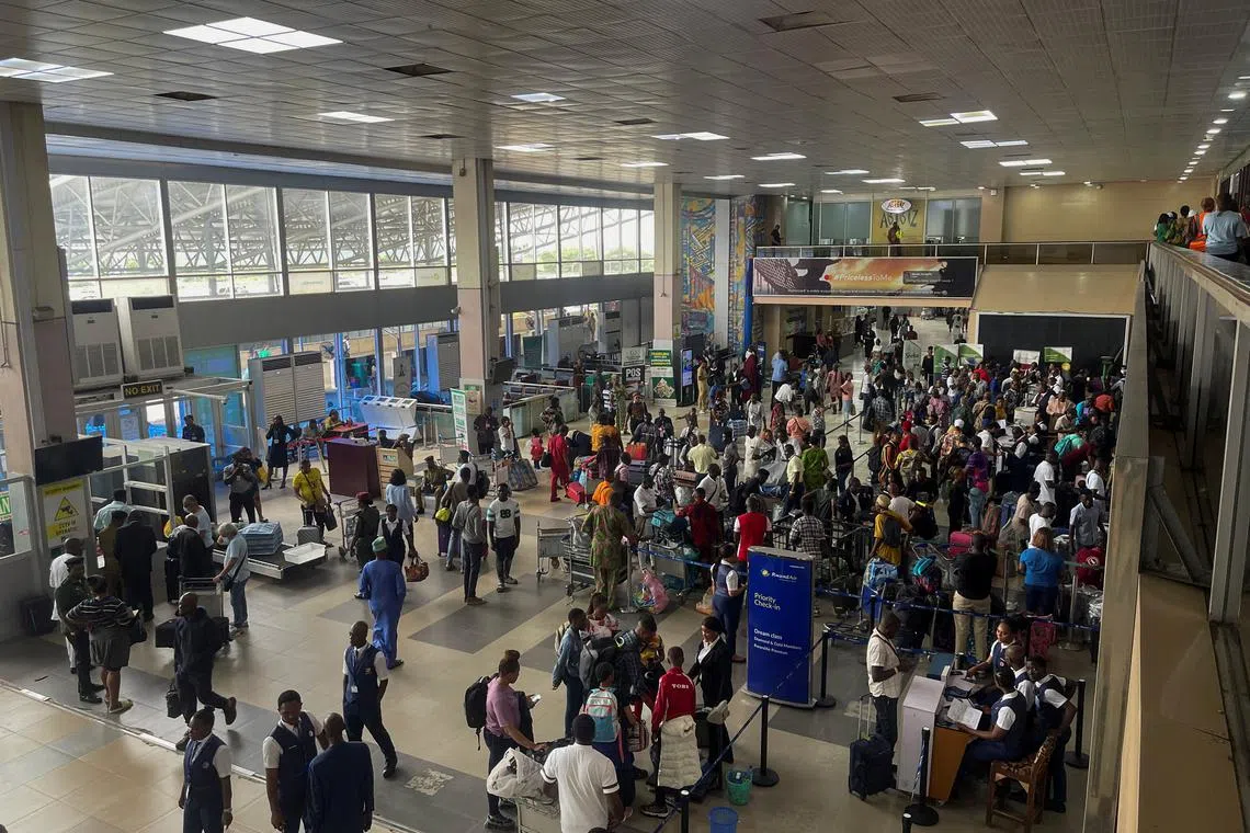 FILE PHOTO: Passengers gather as they check-in their luggages at Murtala Muhammed International Airport in Lagos, Nigeria September 30, 2022. REUTERS/Temilade Adelaja/File Photo