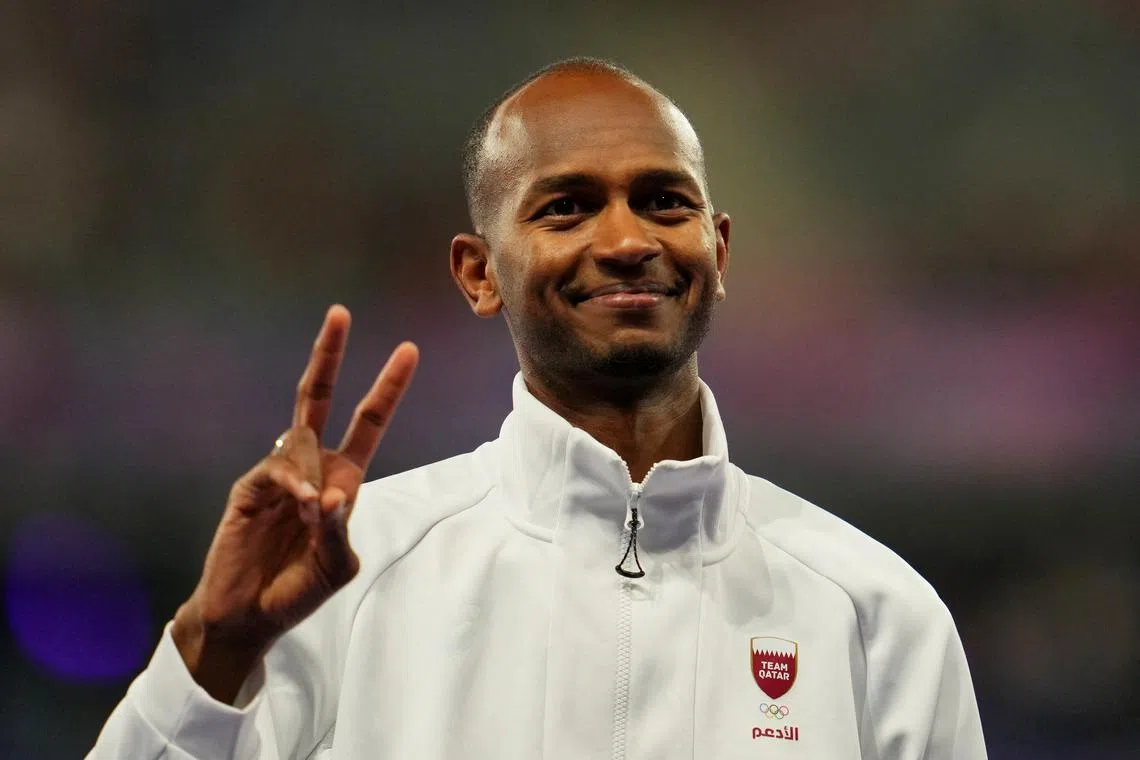 FILE PHOTO: Paris 2024 Olympics - Athletics - Men's High Jump Victory Ceremony - Stade de France, Saint-Denis, France - August 10, 2024. Bronze medallist Mutaz Essa Barshim of Qatar celebrates on the podium. REUTERS/Aleksandra Szmigiel/ File Photo
