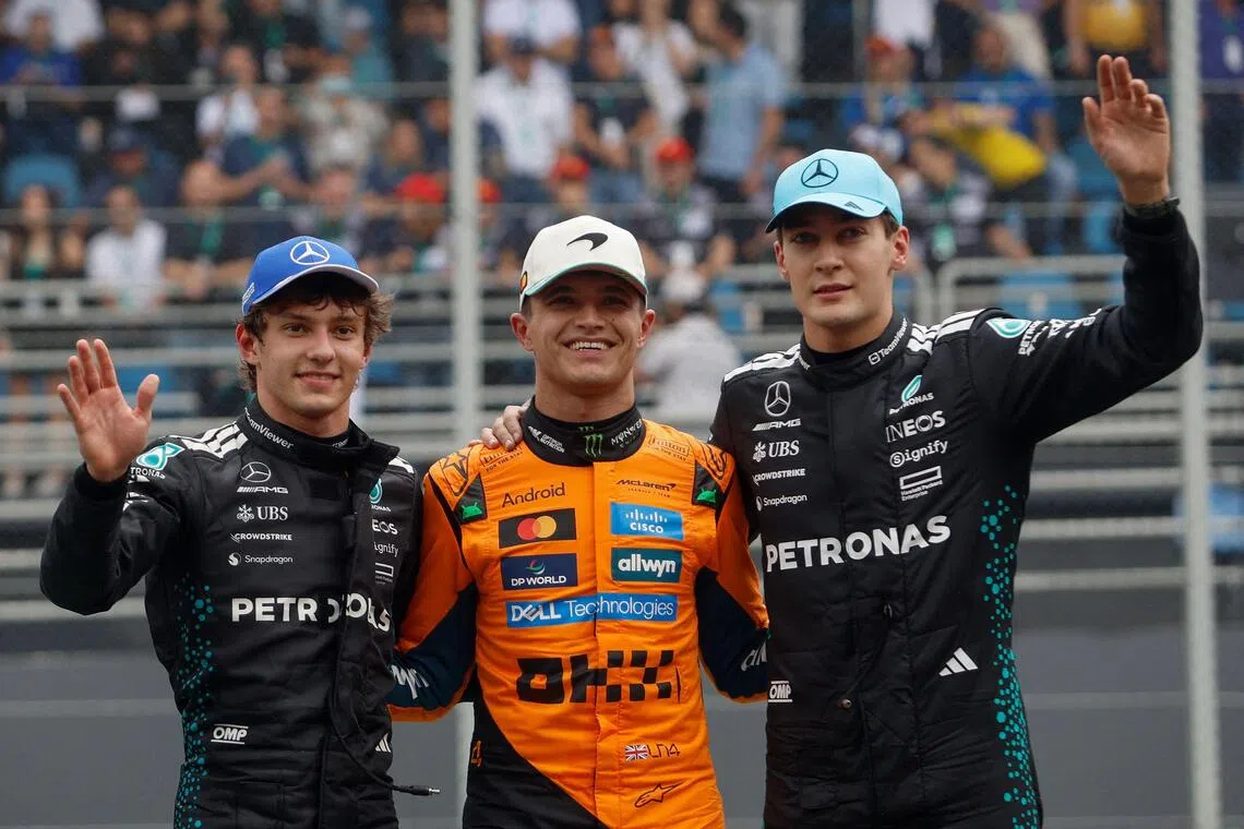 Sprint winner Lando Norris (centre), with Kimi Antonelli (left), who took second place, and third-placed George Russell.