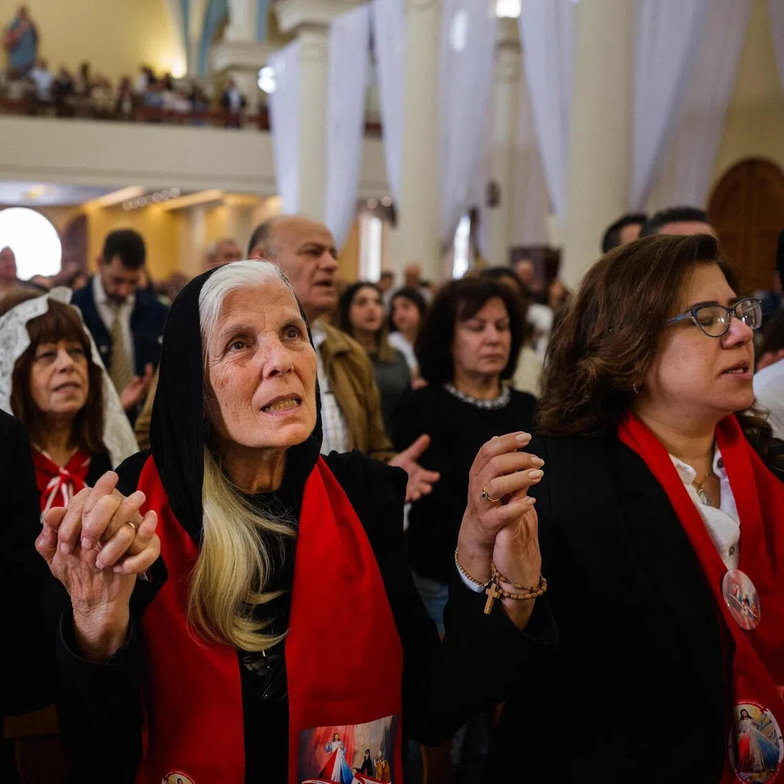 Lebanese Maronite Christian worshippers pray during the Easter Sunday service at the Saint Antoine Church in Beirut on April 5.