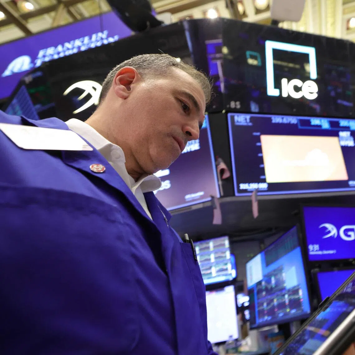 Traders working on the floor of the New York Stock Exchange at the opening bell on Dec 3, in New York City.