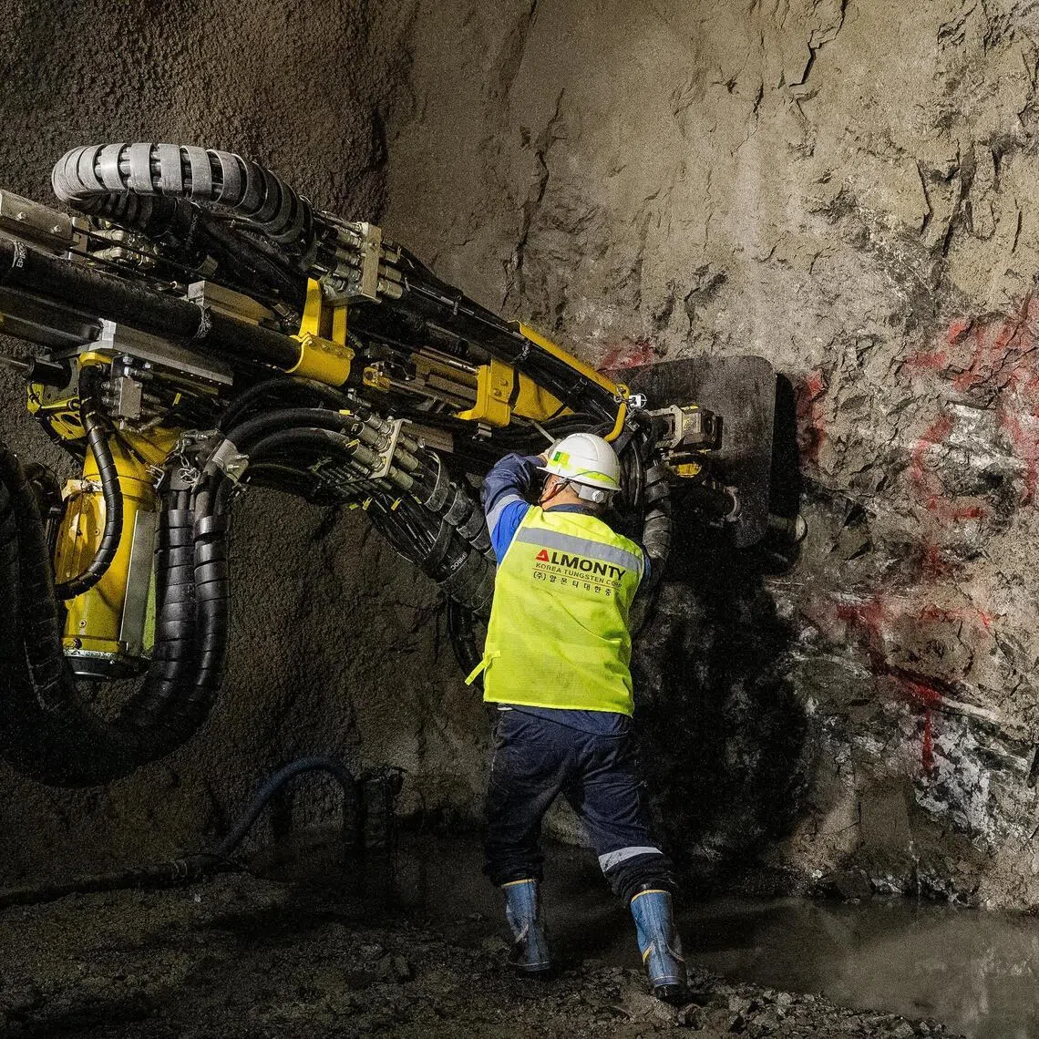 Workers operate a longhole drill inside the tungsten mine in Sangdong, South Korea, on June 2.