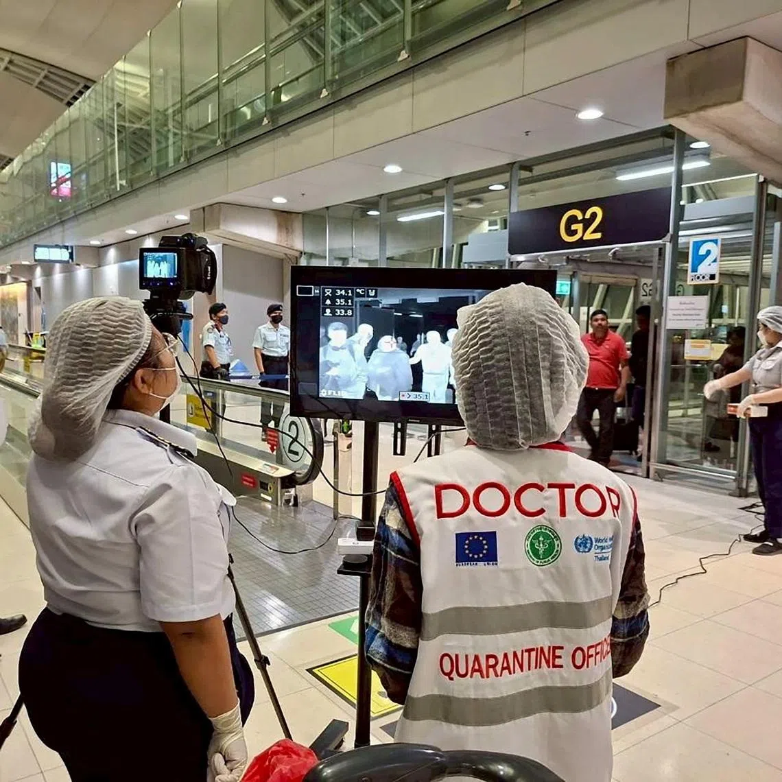 Airport health authorities wearing protective masks monitor passengers from international flights arriving at Suvarnabhumi International Airport in Bangkok, Thailand, January 25, 2026, following the implementation of health screening measures for passengers arriving from West Bengal, India, amid reports of a Nipah virus outbreak. Suvarnabhumi Airport Office /Handout via REUTERS