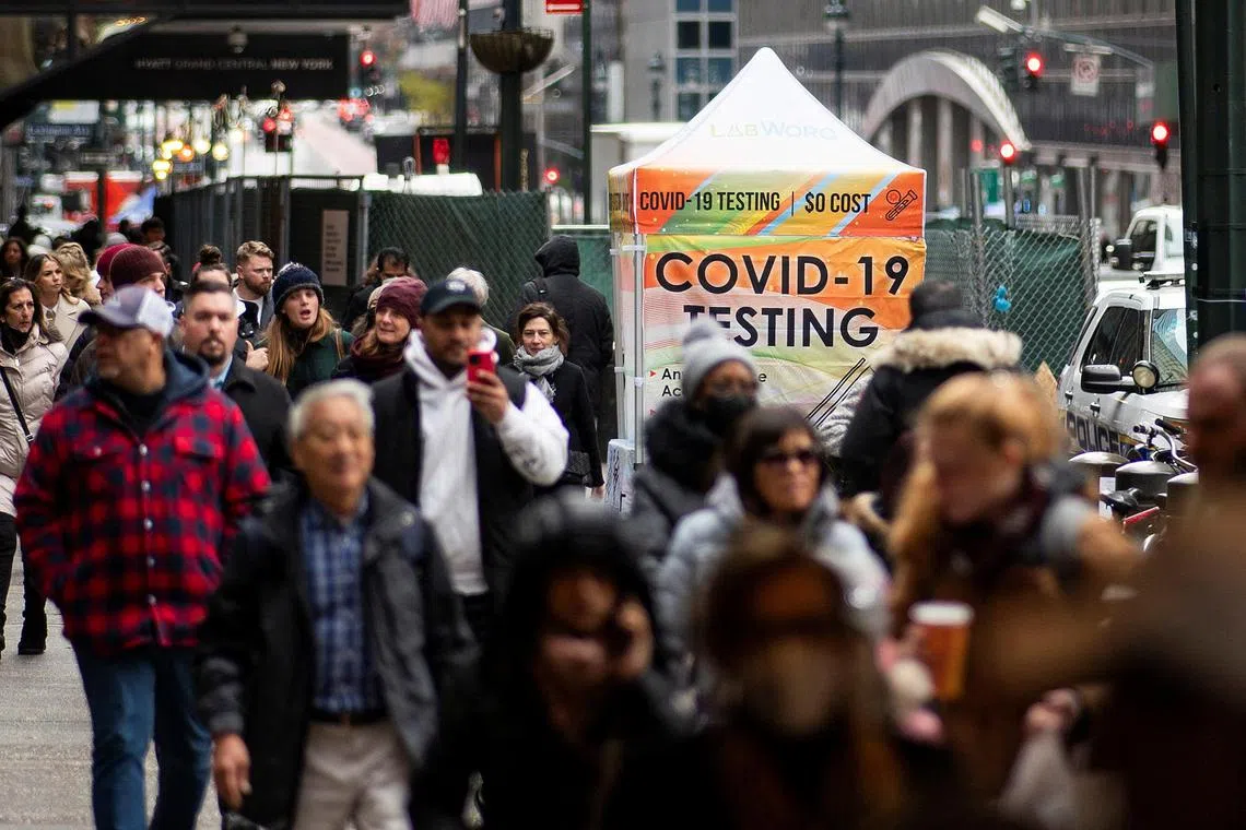 People walk next to a coronavirus disease COVID-19 testing site in New York City, New York, U.S., December 12, 2022. REUTERS/Eduardo Munoz