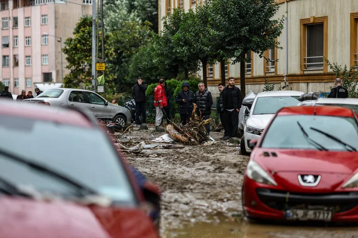 Car owners searching for their vehicles swept away by the flood after a heavy rain at Ayazaga district in Istanbul, on Oct 15.