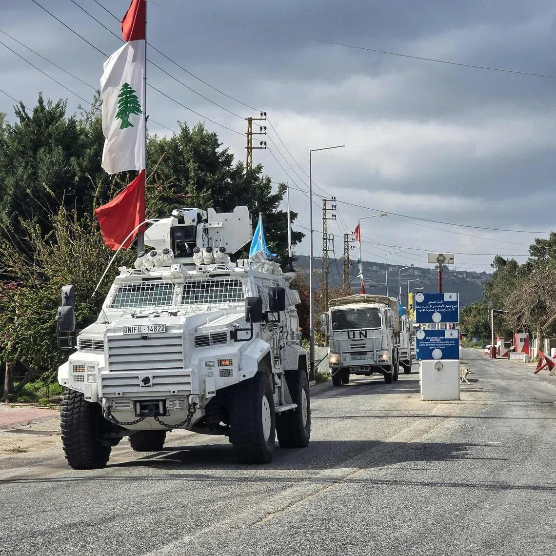 Peacekeepers with the UN Interim Force in Lebanon (UNIFIL) drive past a Lebanese army outpost in Naqura, southern Lebanon, on March 27.
