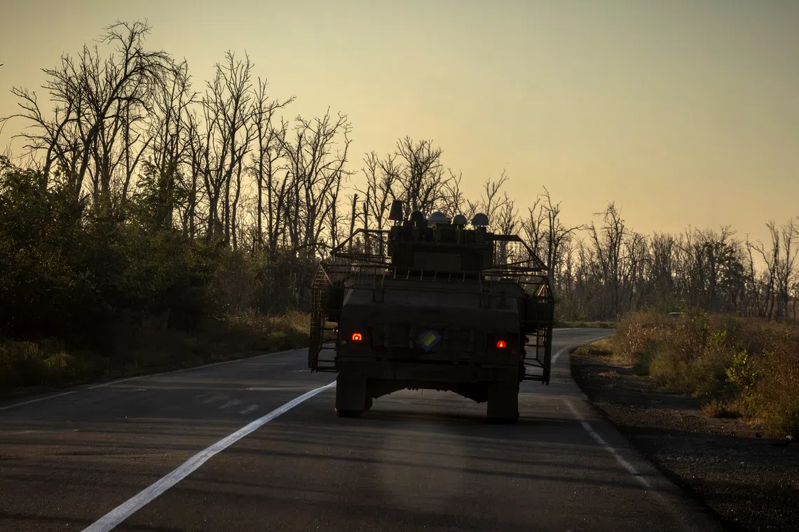 An Ukrainian armored vehicle with a protective anti-drone cage drives on a road, amid Russia's attack on Ukraine, outside Sloviansk, Ukraine September 11, 2025.  REUTERS/Thomas Peter