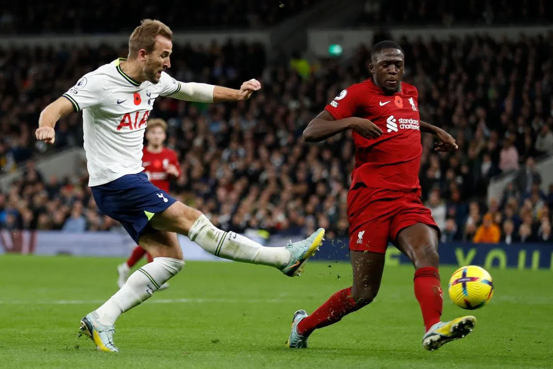 Tottenham's Harry Kane (left) scoring his team's first goal past Liverpool's French defender Ibrahima Konate during Spurs' 2-1 loss in the English Premier League on Sunday. 