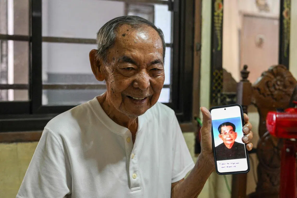 Mr Jose Villafuerte showing a mobile phone with a photo of his father Ginjiro Takei, a Japanese imperial army officer, during an interview with AFP.