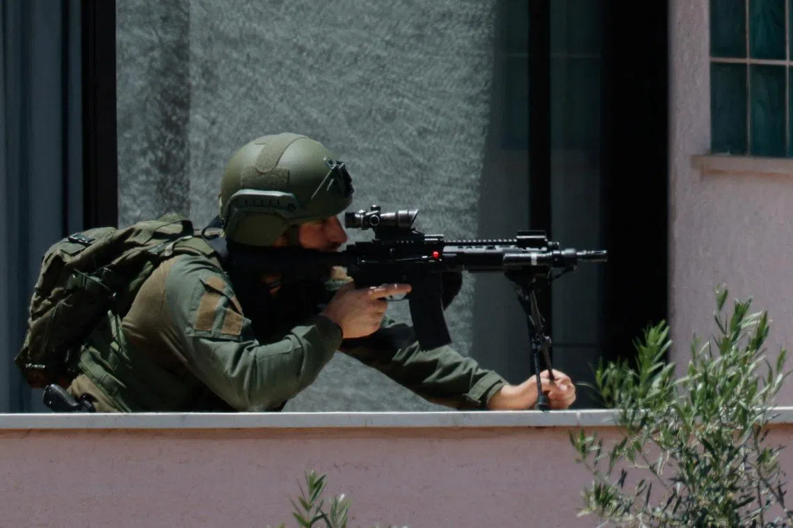 An Israeli soldier looks through the sight of his rifle, at his position near the border with Lebanon, in northern Israel, May 31, 2026. REUTERS/Amir Cohen