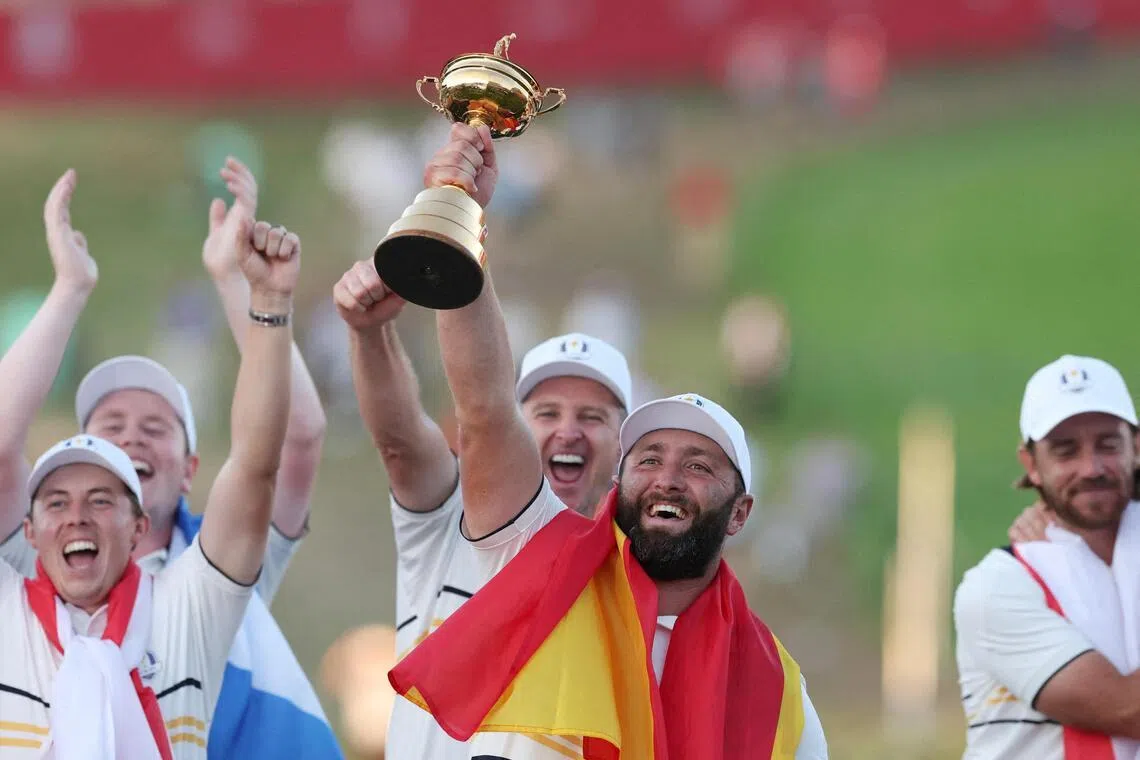 Team Europe's Jon Rahm celebrates with the trophy during the presentation after winning the 2025 Ryder Cup.