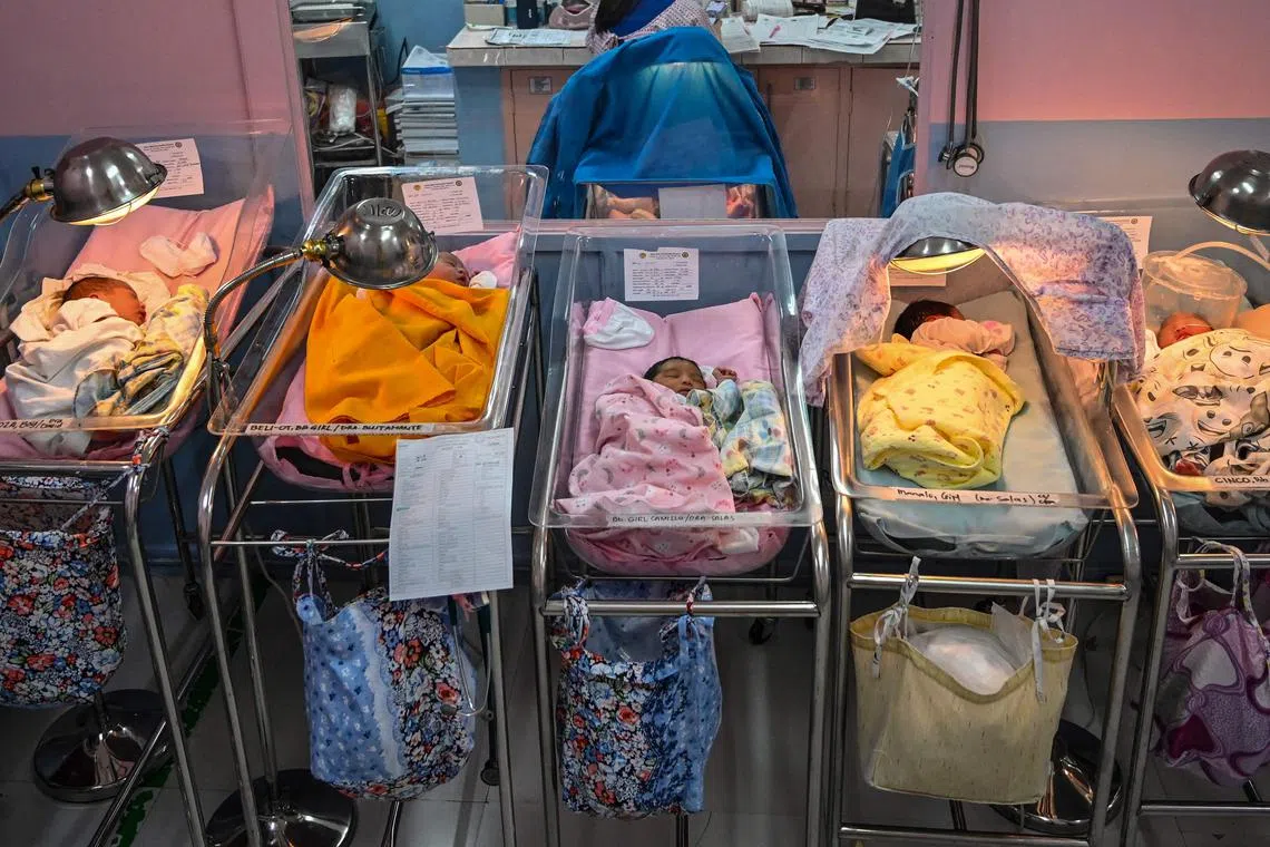 This picture taken on October 22, 2022 shows newborn babies seen inside their cribs at a hospital in Santa Rosa, Laguna. - The global population will breach the symbolic level of 8 billion on November 15, according to the UN. The milestone comes as questions are increasingly being raised about the measures needed to adapt to global warming, as well as about how humanity consumes Earth’s resources. (Photo by JAM STA ROSA / AFP)